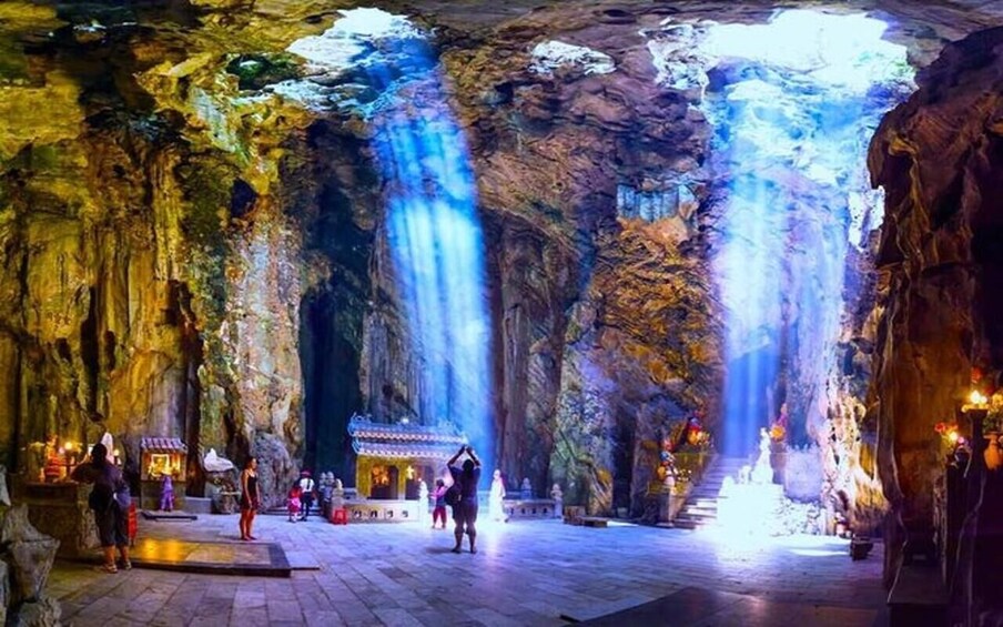 A cave with waterfalls and a temple. 1