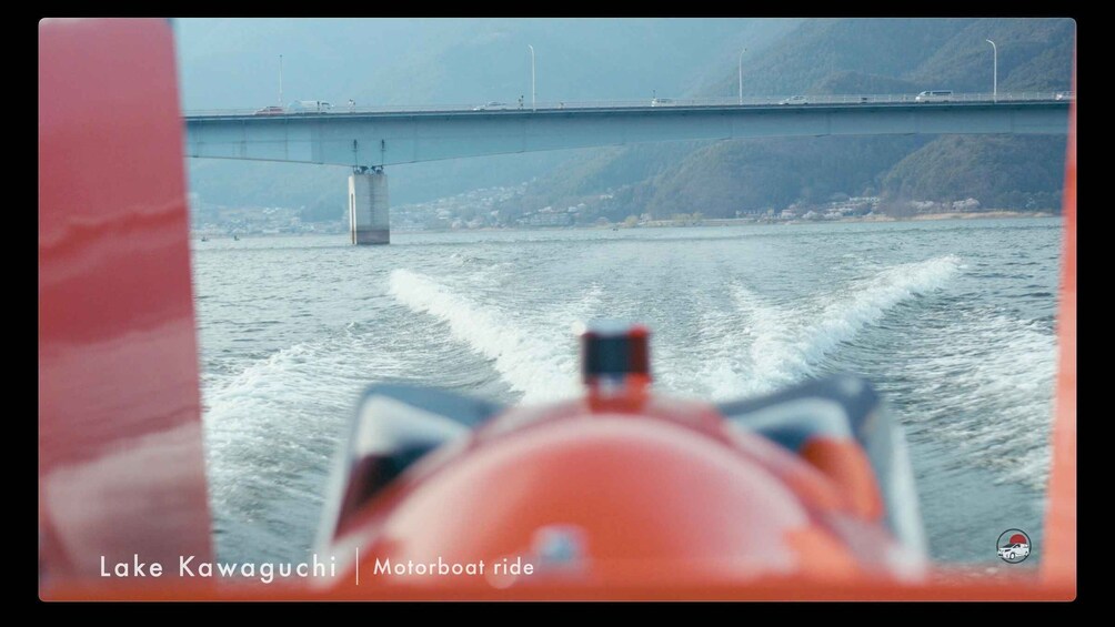 A motorboat on Lake Kawaguchi with a bridge in the background. 5
