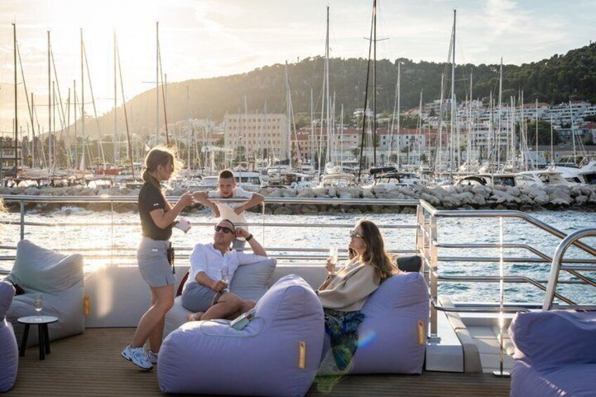 People relaxing on a boat with a marina and boats in the background. 4