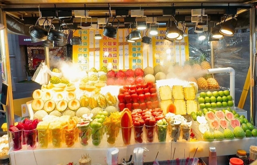 A fruit stand with various fruits and vegetables on display. 2