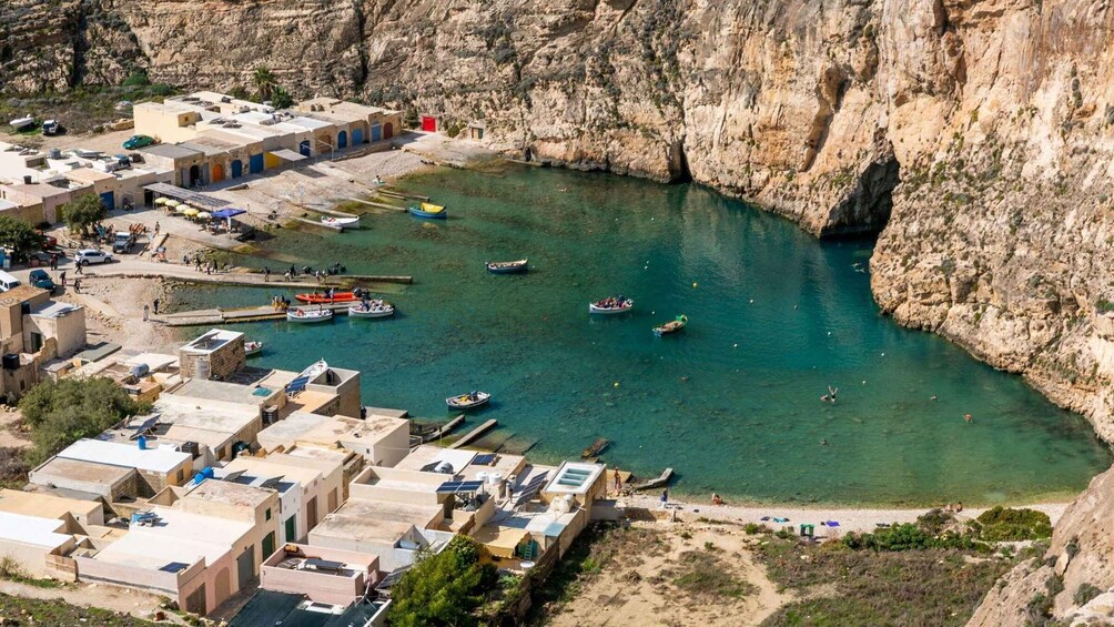 A coastal village with boats docked at a harbor, surrounded by cliffs. 5