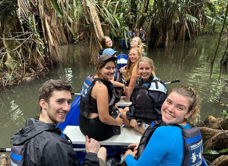 A group of people on a riverboat in a mangrove area. 4