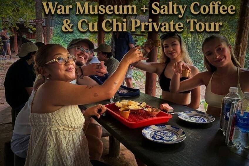 A group of people at a picnic with a War Museum and Cu Chi Private Tour sign. 3