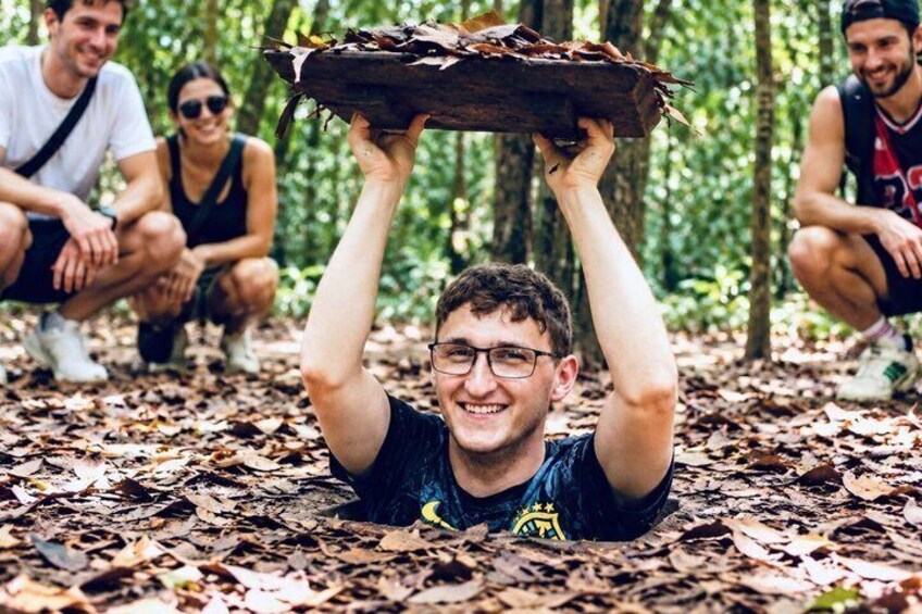 A person holding a wooden board above their head in a forest. 1