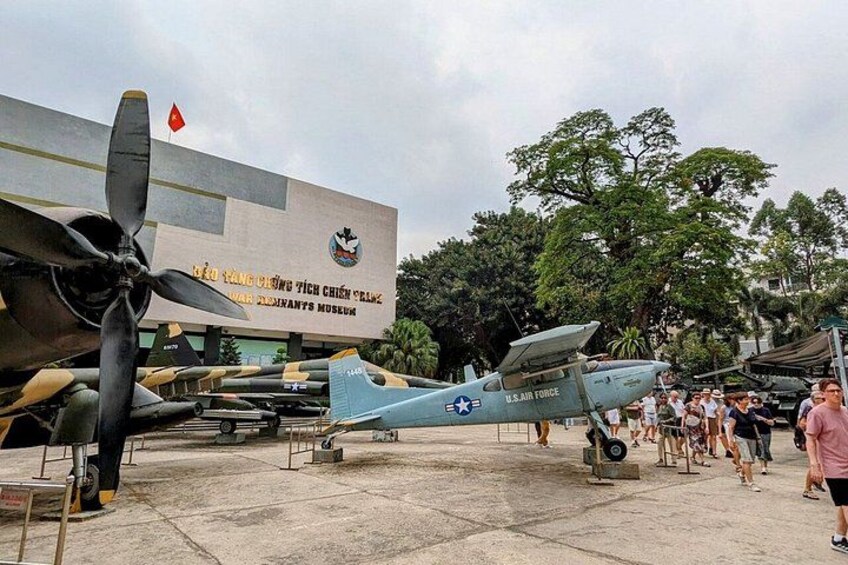 A military aircraft on display at a museum with a crowd of visitors. 5