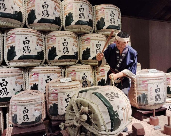 A person handling large sacks of rice with Japanese characters on them. 4