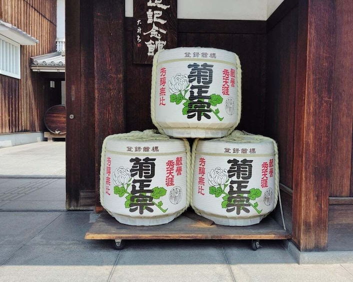 Three large containers stacked on a wooden platform outside a building. 5