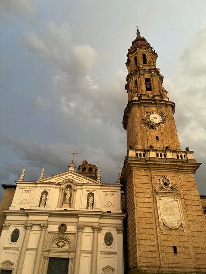 A historic church with a clock tower and a bell. 5