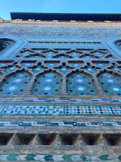 A detailed mosaic with geometric patterns and star motifs. 3