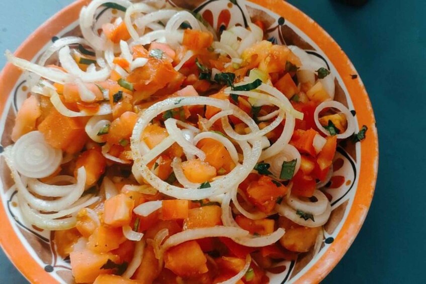 A bowl of diced mango and onion salad with herbs. 3