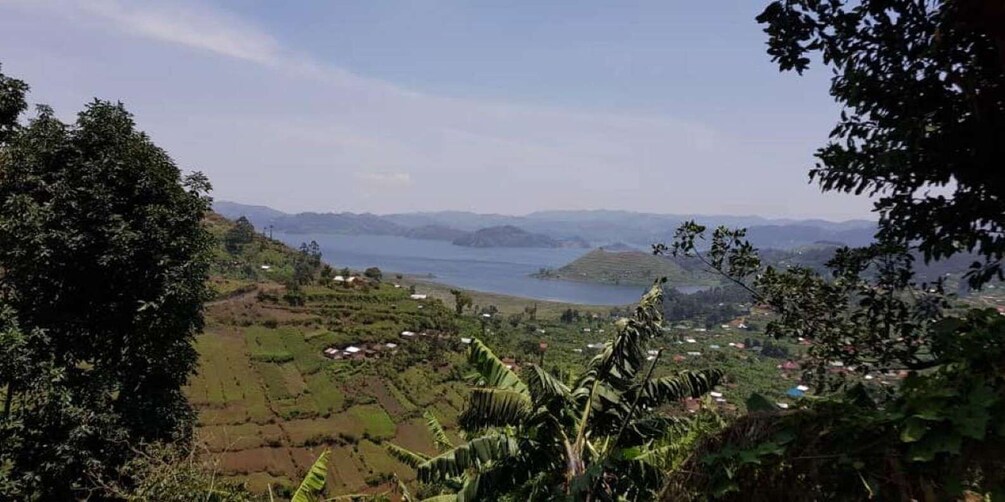 A mountainous landscape with a lake and scattered houses. 1