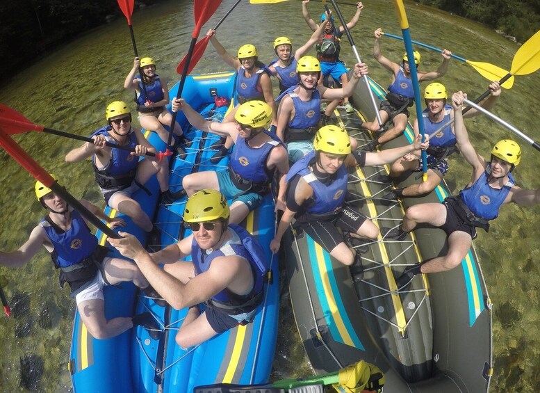 A group of people in inflatable rafts on a river, wearing helmets and life jackets. 2