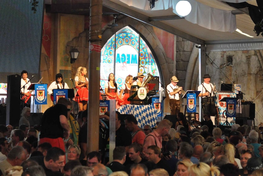 A band performing on a stage with a crowd in front. 2