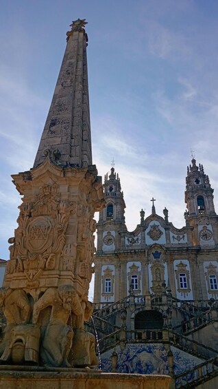 A historic church with ornate architecture, including a bell tower and a prominent obelisk. 1