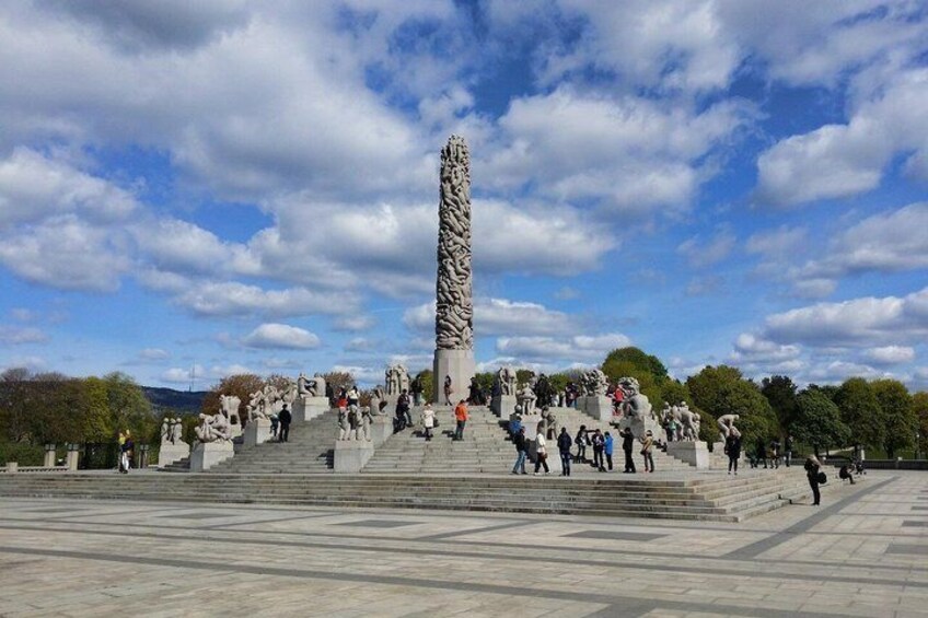 A large monument with intricate carvings, surrounded by a spacious plaza with steps leading up to it. 3