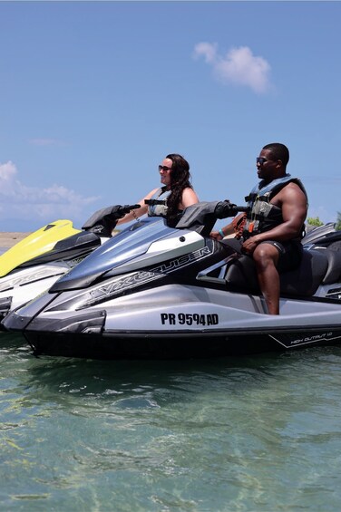 Two people on a jet ski with a clear sky in the background. 4