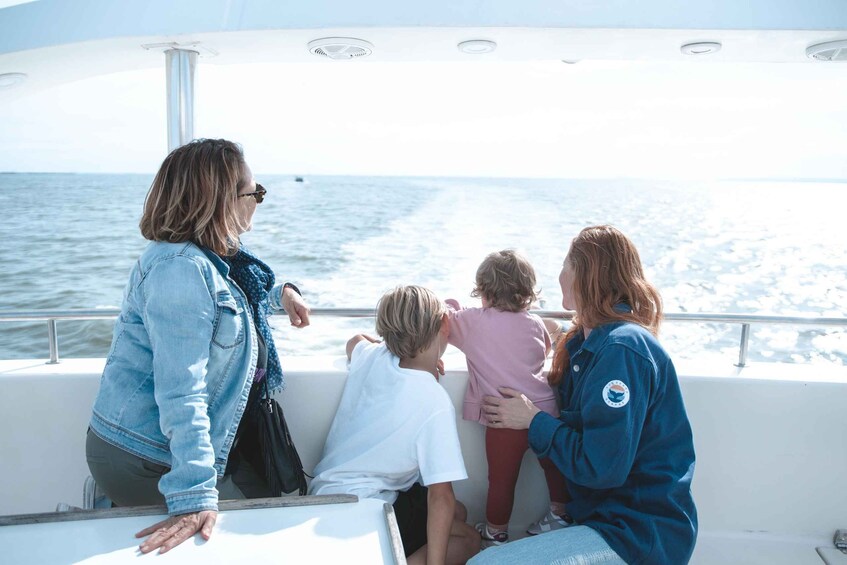 A family on a boat with a view of the ocean. 4