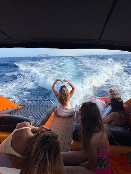 A group of people on a boat with the ocean in the background. 4