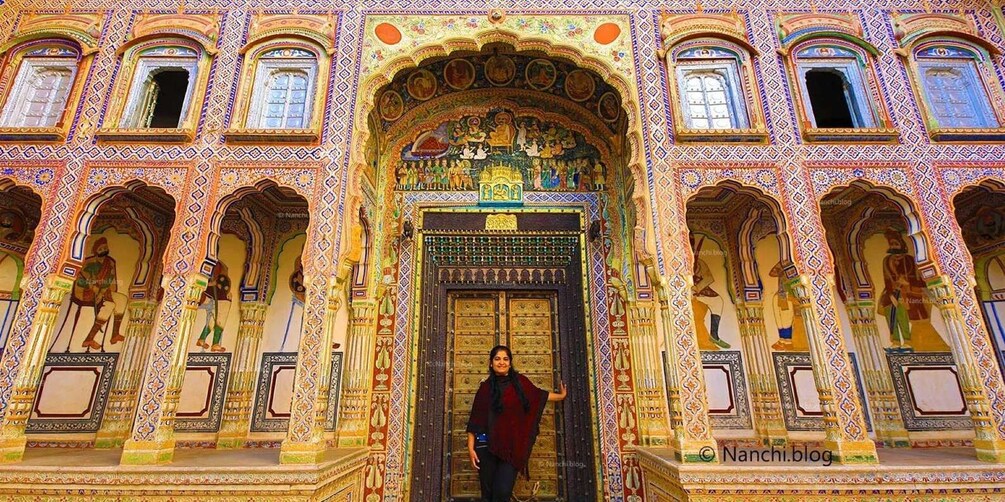 A richly decorated building facade with intricate patterns and a central doorway. 4