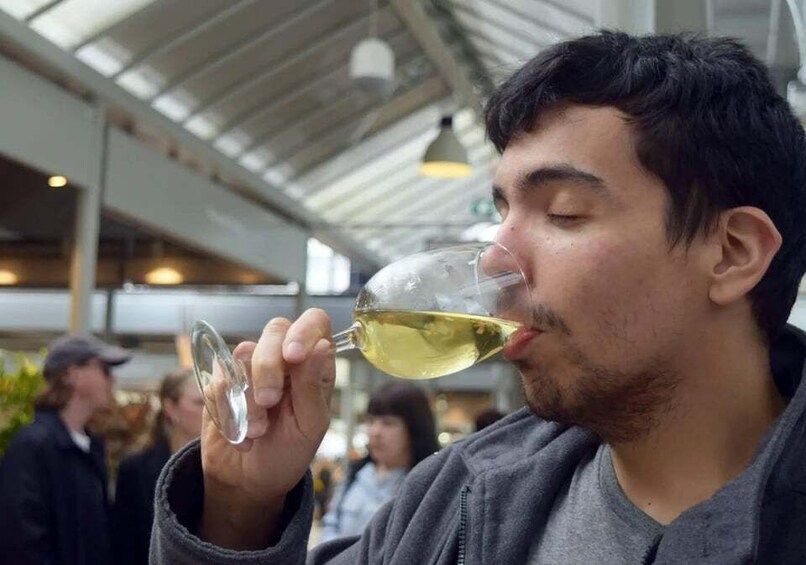 A person holding a wine glass. 3