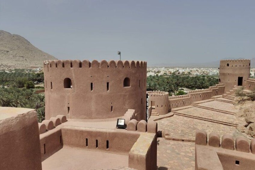 A desert fort with multiple towers and a clear sky. 5