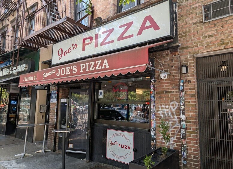 Joe's Pizza storefront with a red awning, a visible ATM, and a brick building facade. 5