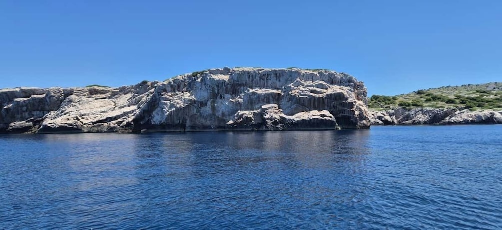 A rocky coastline with clear blue water. 2