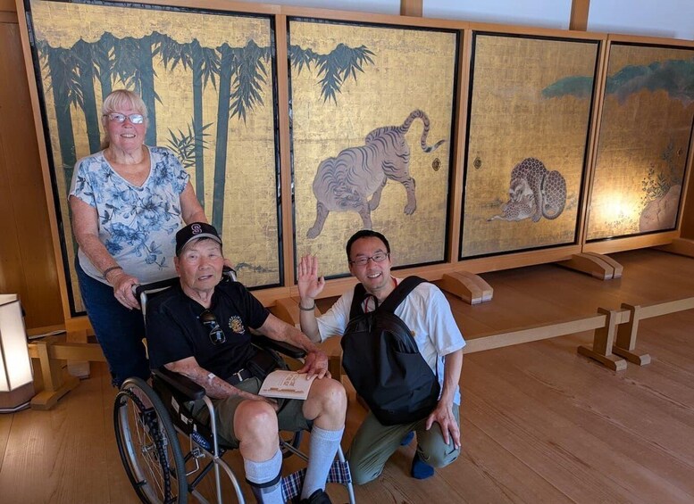 A group of people in a museum with traditional Asian art. 4