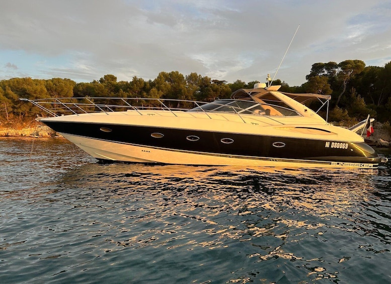 A black and white yacht named 'SUNSEEKER' with registration number 'NI D80069' on calm water. 1