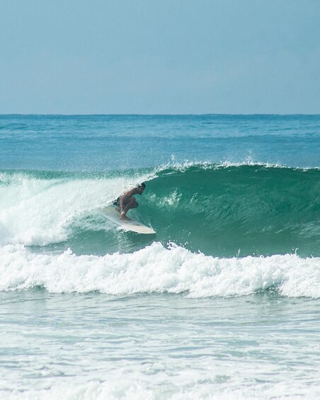 A surfer riding a wave in the ocean. 5