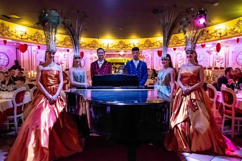 A formal event with a piano, attendees in elegant attire, and ornate decorations. 4
