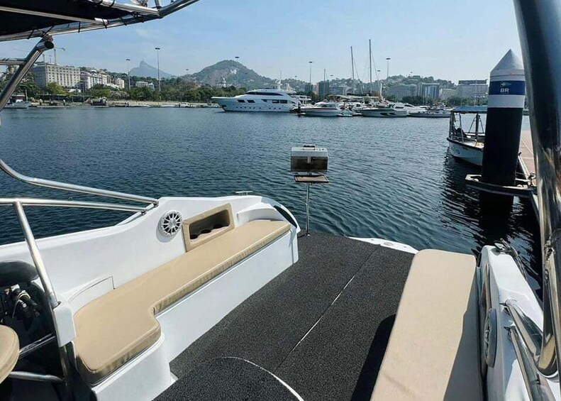 A marina with boats docked, a cityscape in the background, and a clear sky. 5