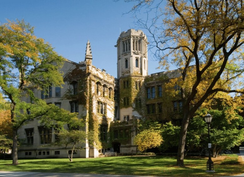A historic building with ivy-covered walls and a prominent tower. 4