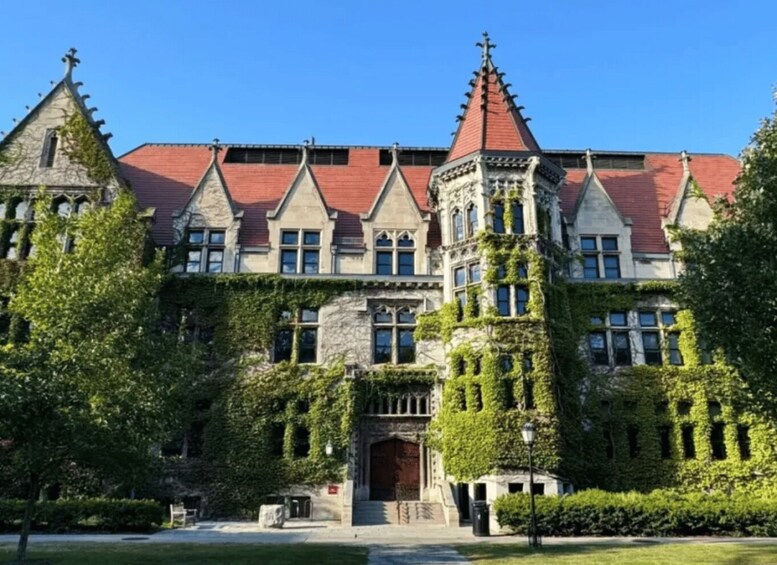 A large, ivy-covered building with multiple pointed roofs and a central entrance. 3