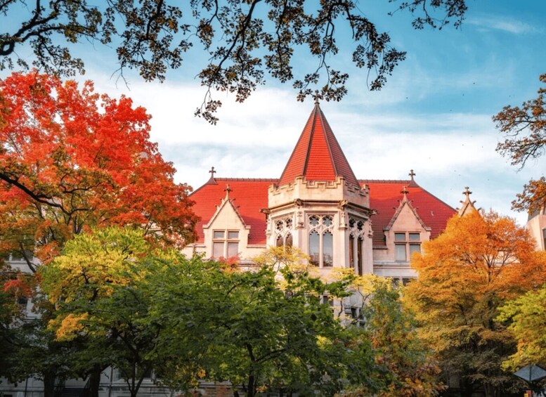 A church with a red roof and a pointed steeple, surrounded by autumn-colored trees. 1