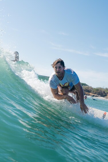 A person surfing a wave in the ocean. 1