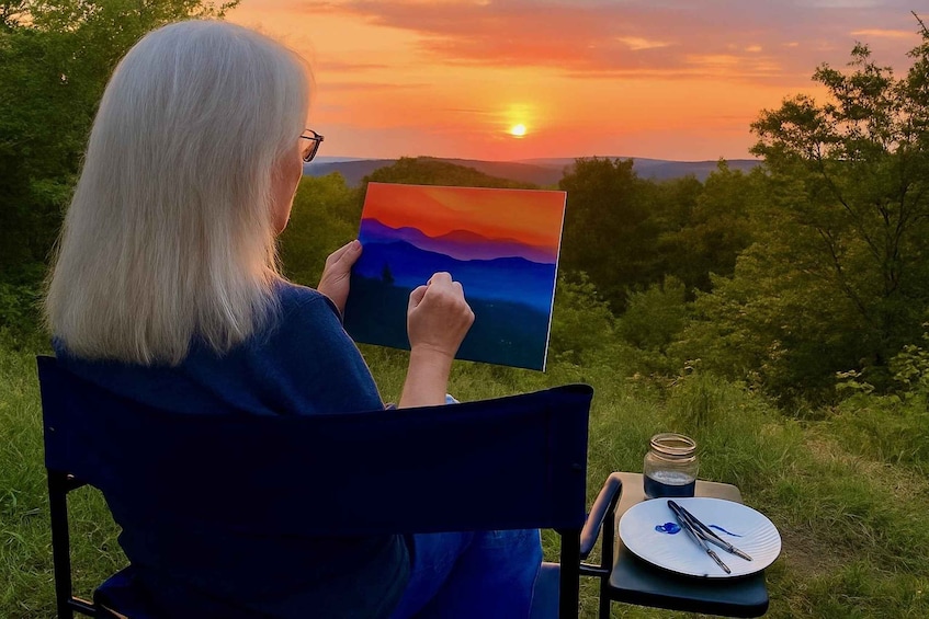 A person painting a landscape with a sunset in the background. 1
