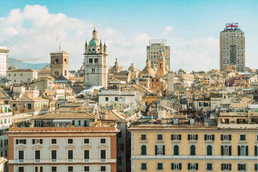 A densely packed urban landscape with historic architecture, including a prominent church with a dome and bell tower, and a modern high-rise building with a flag. 1