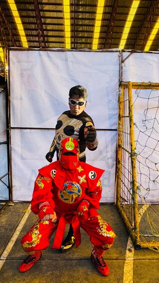 A person in a red costume with gold accents, holding a large red and gold shield. 2