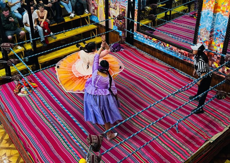 A traditional dance performance with colorful costumes and a patterned floor. 4