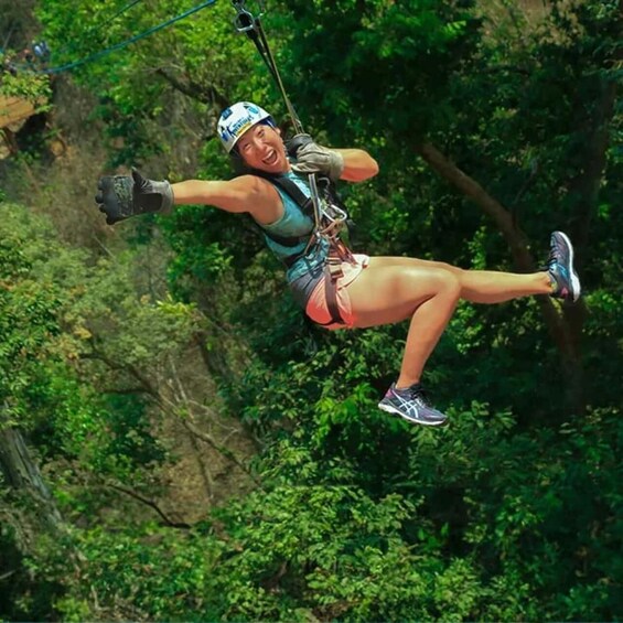 A person bungee jumping from a cliff, harnessed and suspended by a rope. 2