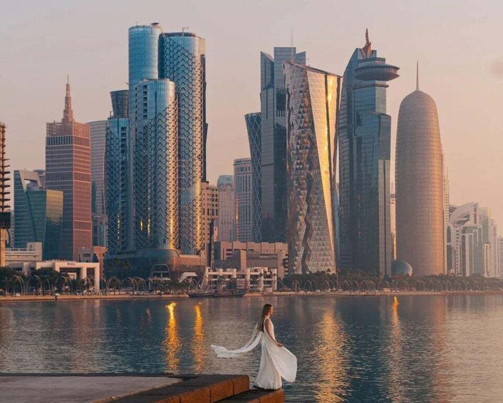 A cityscape with modern skyscrapers and a body of water reflecting the buildings. 1