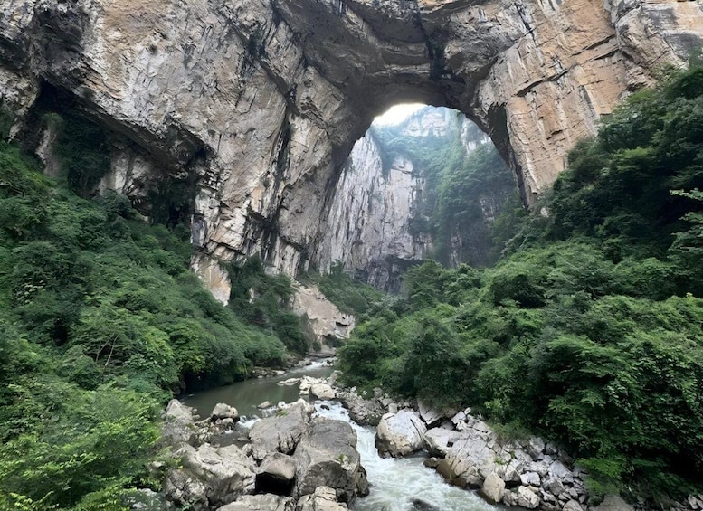 A river flowing through a rocky gorge with dense foliage on either side. 2
