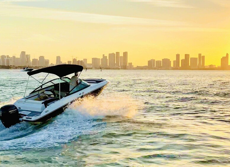 A speedboat on water with a city skyline in the background. 1