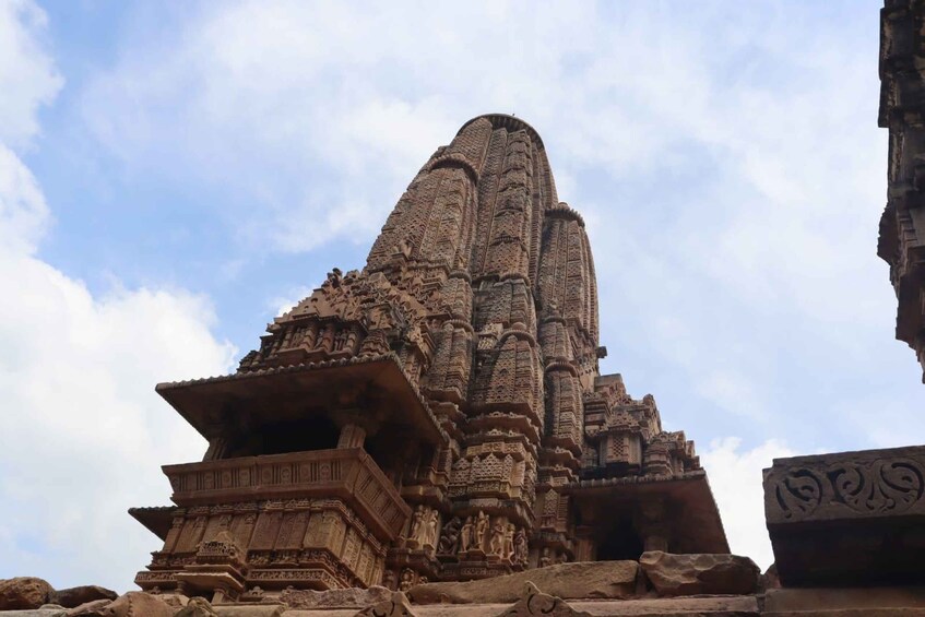 A large, intricately carved stone structure with a pointed top, possibly a temple or monument. 3