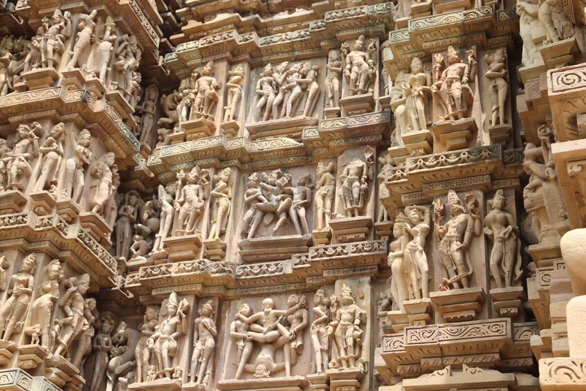 A detailed stone carving of multiple figures in various poses, likely depicting mythological or historical scenes. 1