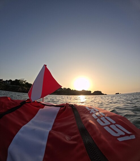 A red and white life jacket with the number 9597 on a boat at sunset. 2