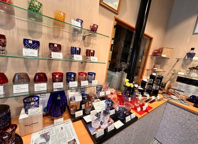 A glassware display with various items and price tags. 1