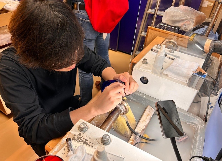 A person working on a mechanical device with tools and a workbench. 3