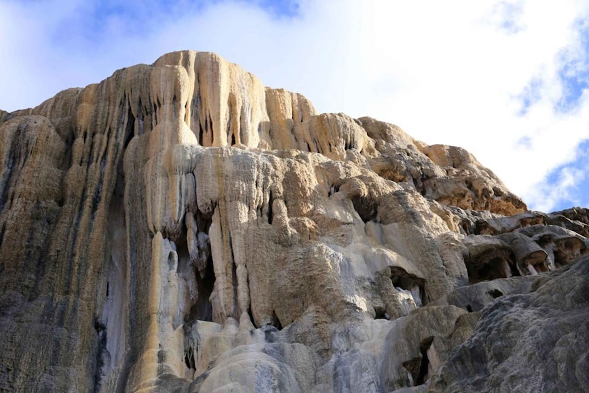 A large rock formation with vertical striations and a rugged surface. 2
